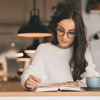 Acupuncture for hormonal balance Woman Reading Book At A Desk